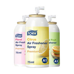 Three Tork A1 air freshener spray bottles on a white background, including Citrus (yellow), Floral (pink), and Fruit (green) scents.