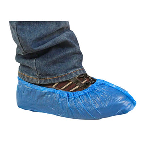 A blue disposable plastic shoe cover worn on a foot, shown with blue jeans and striped socks against a plain white background.