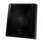 A glossy black square plastic cover or shield with rounded corners and a small shield-shaped cutout near the bottom center, shown on a plain white background.