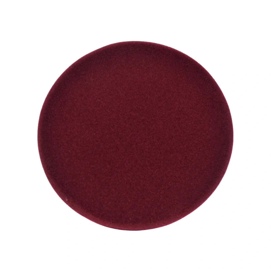 A circular, deep burgundy velvet cushion or pad shown from a top-down view on a solid white background.