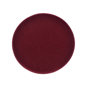 A circular, deep burgundy velvet cushion or pad shown from a top-down view on a solid white background.