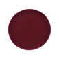 A circular, deep burgundy velvet cushion or pad shown from a top-down view on a solid white background.