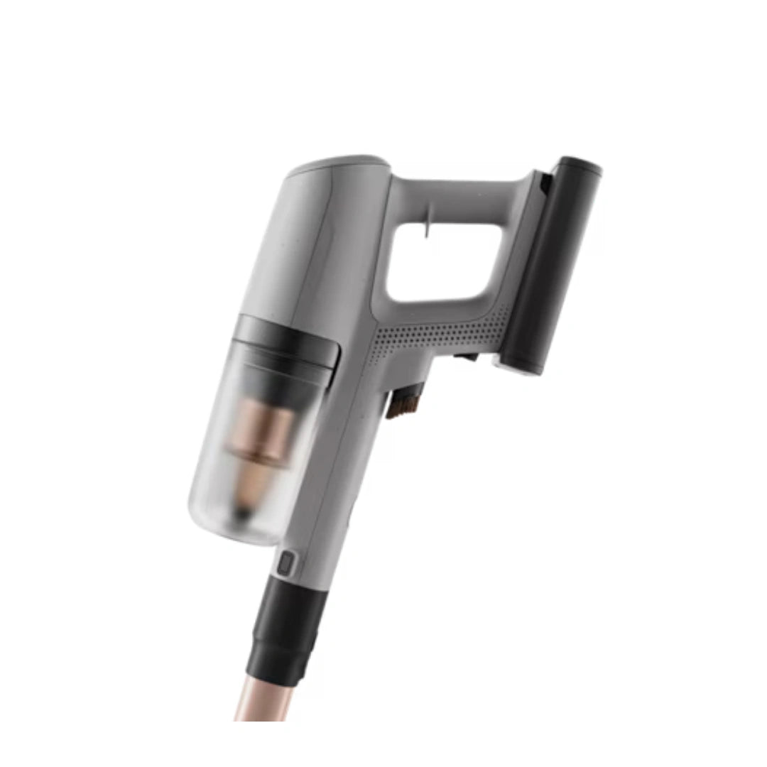 A cordless stick vacuum cleaner with a gray and black body, featuring a transparent dust bin showing a copper-colored filter, set against a plain white background.