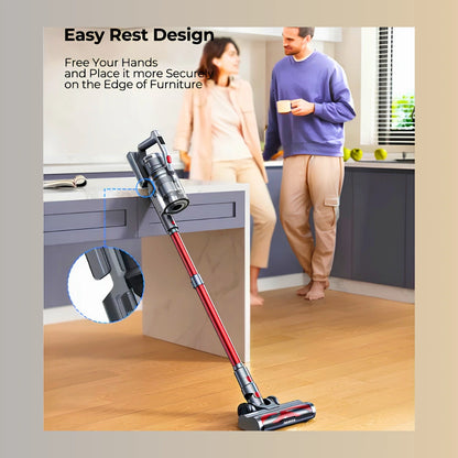 A cordless stick vacuum cleaner with a red handle and dark gray head is shown in a modern kitchen setting, leaning against a countertop. A man and woman are standing in the background, and marketing text at the top reads 'Easy Rest Design' with a circular inset highlighting the vacuum's resting base.