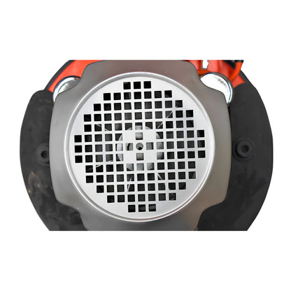 A close-up of a circular metal engine or motor component with a silver perforated grille, black rubber seals, and orange mechanical parts visible behind it, isolated on a white background.