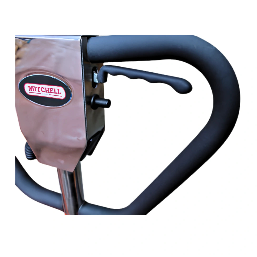 Close-up of a Mitchell brand piece of machinery or equipment, showing a black curved handlebar, black lever, and a metallic silver body with a black and red Mitchell logo badge.