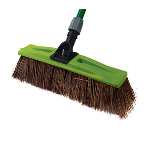 A green and black plastic broom head with brown bristles, attached to a green handle, shown on a plain white background.