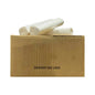 Three rolls of white plastic sanitary bin liners stacked on top of a brown cardboard box with the text 'SANITARY BIN LINER' printed on the front, set against a plain white background.