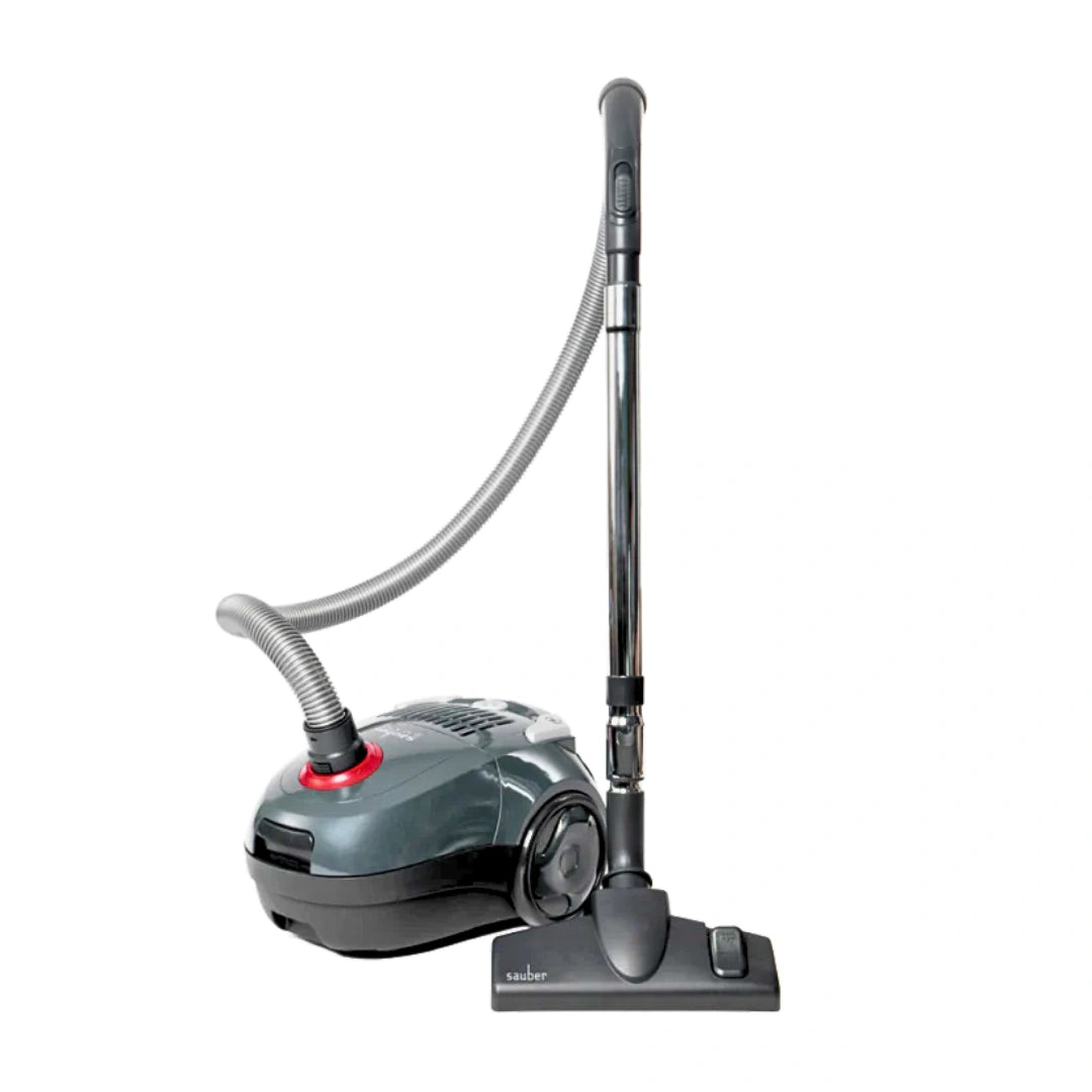 A vacuum cleaner with a dark gray and black body, a flexible gray hose, and a long black wand with a floor head, shown on a plain white background.