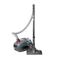 A vacuum cleaner with a dark gray and black body, a flexible gray hose, and a long black wand with a floor head, shown on a plain white background.