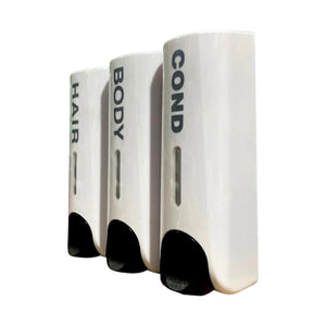 Three white cylindrical dispenser units labeled HAIR, BODY, and COND, arranged in a row on a plain white background.