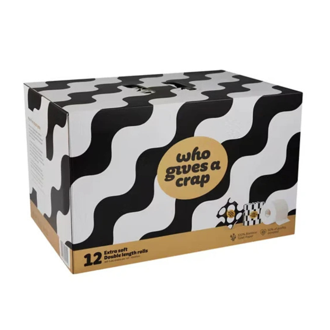 A box of toilet paper rolls with a black and white wavy pattern, a tan circular label reading 'who gives a crap', and a tan base band on a white background.