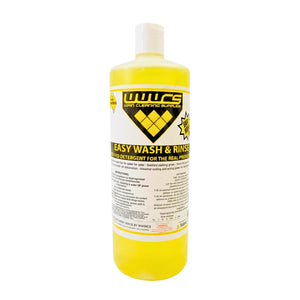 A bottle of WWCS Easy Wash & Rinse liquid detergent for real motor oil, filled with bright yellow liquid and featuring a white cap on a white background.