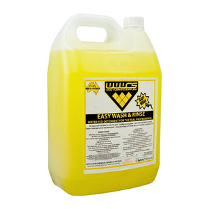 A large plastic jug of WWCS Easy Wash & Rinse water fid detergent, filled with bright yellow liquid, on a plain white background.