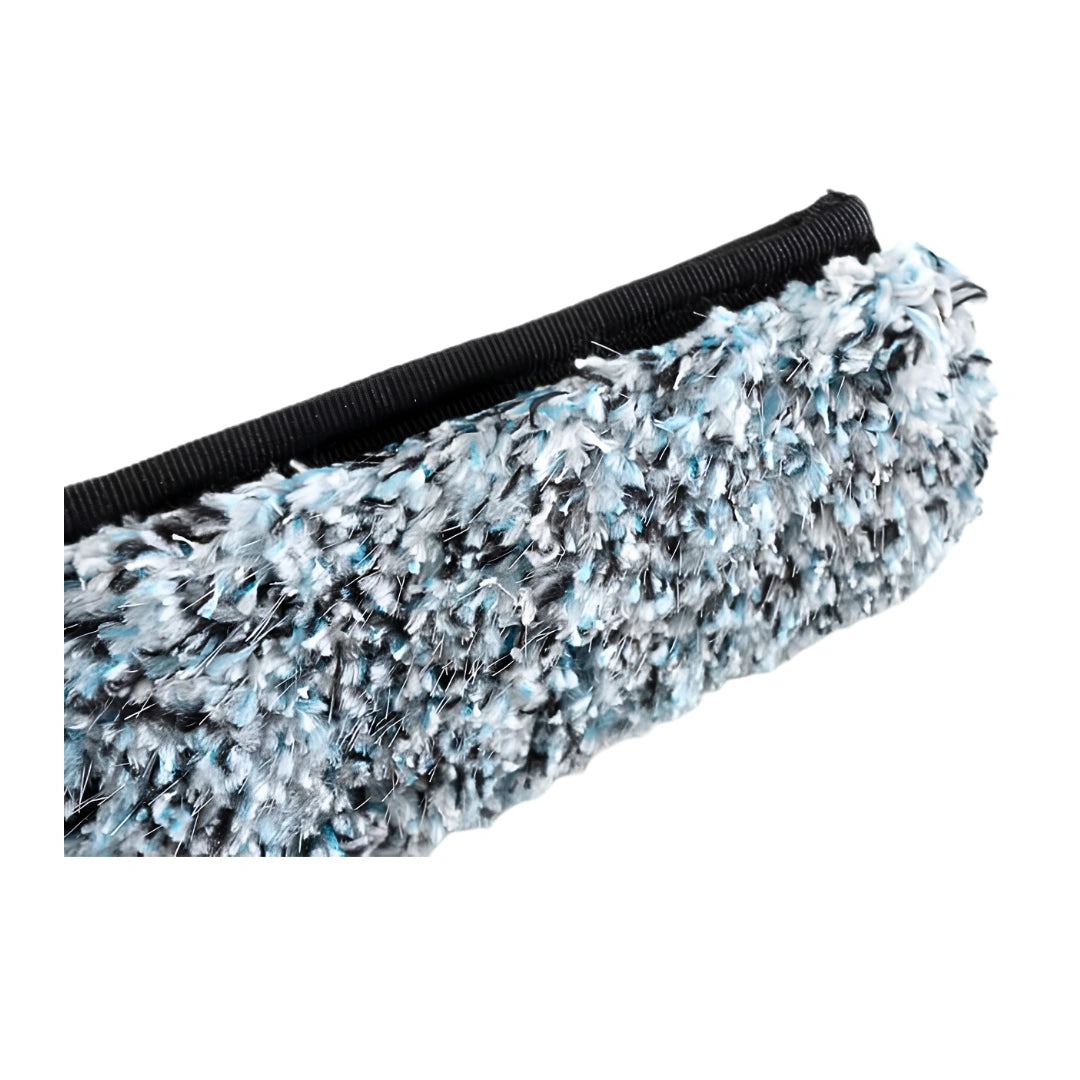 Close-up of a textured, shaggy faux fur or terry cloth material in a variegated mix of light blue, white, and black, attached to a black ribbed fabric backing, shown on a plain white background.
