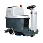 A Onifiskf FCI2000-12 driving snowmobile-style floor cleaner with a white and dark gray body, black steering wheel, and blue cleaning brush at the front, shown on a plain white background.