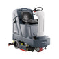 A Nilfisk industrial ride-on floor cleaner with a gray and white body, black seat, and red and yellow operational details, shown on a solid white background.