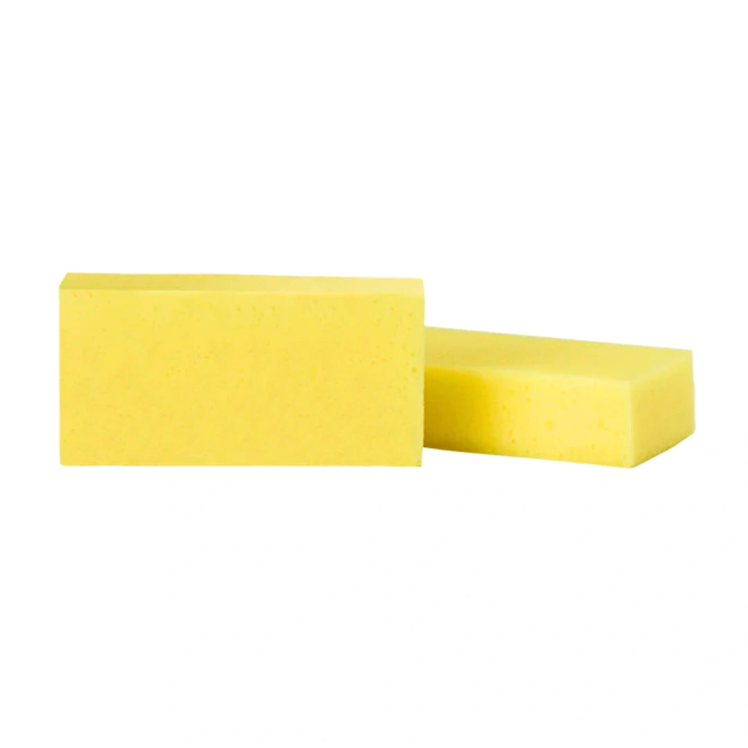 Two rectangular yellow sponge blocks, one standing upright and the other lying flat, shown on a plain white background.