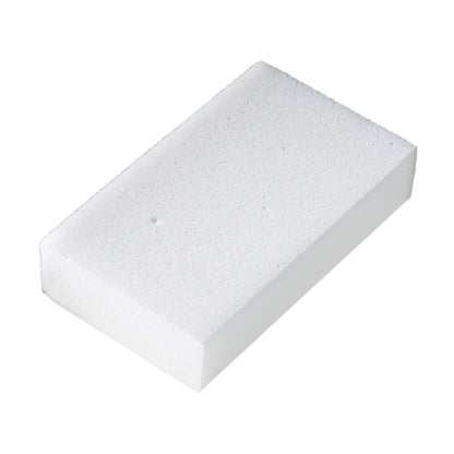 A rectangular white foam sponge block with a textured, porous surface, shown at an angle on a plain white background.