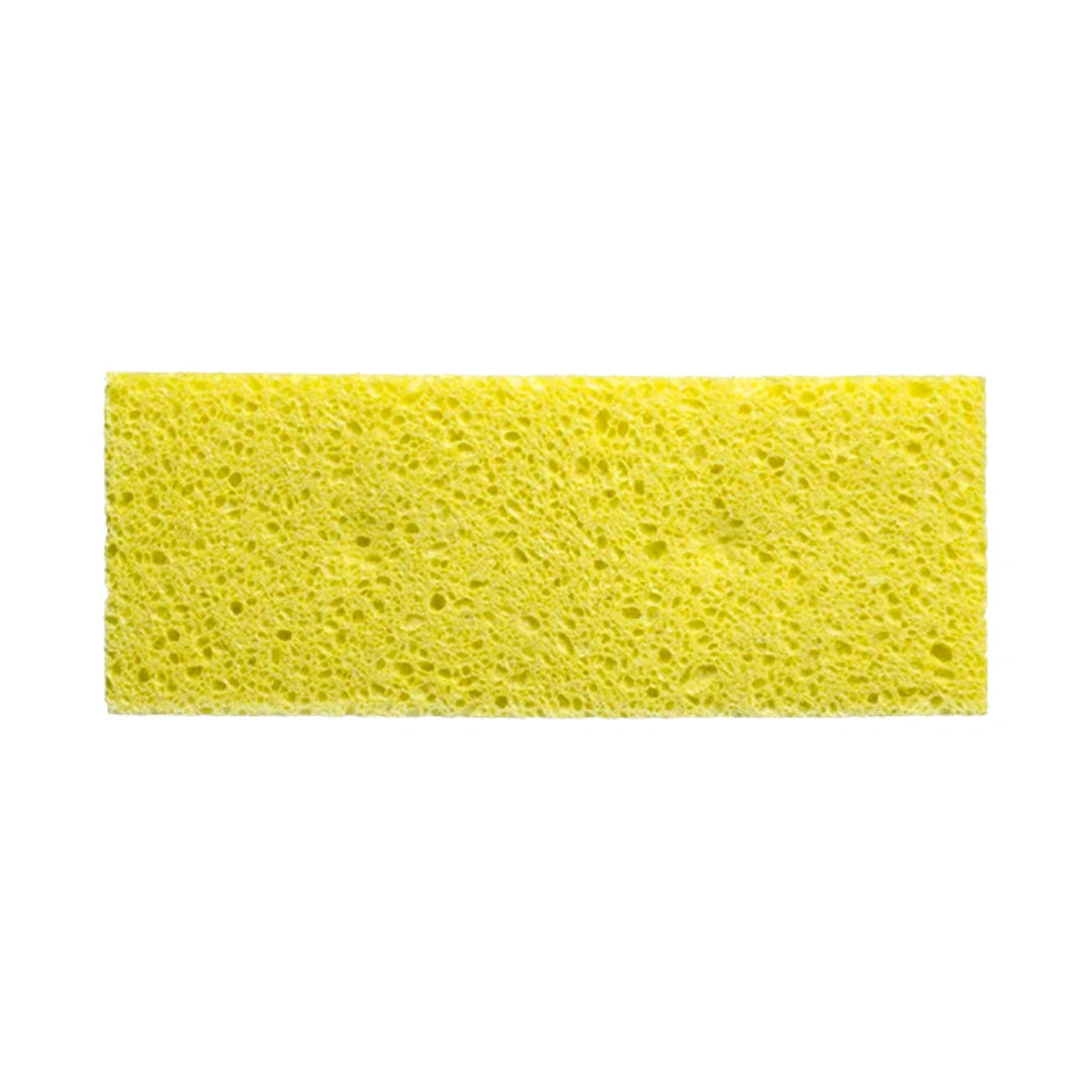 A rectangular yellow sponge with a porous, textured surface, shown against a plain white background.