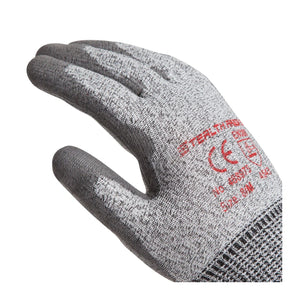 A single knit work glove shown on a white background, with a gray knit body and darker gray coated finger and palm areas. Red printed text and a CE mark are visible on the back of the hand.