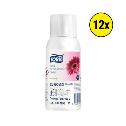 A white plastic bottle of Tork Floral Air Freshener Spray on a white background, featuring a pink gerbera daisy graphic on the label and a yellow circular badge with '12x' in the top right corner.