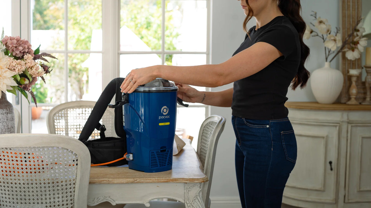 Commercial cleaner using Pacvac Velo backpack vacuum in tight spaces